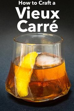 a close up of a drink in a glass with ice and lemon on the rim