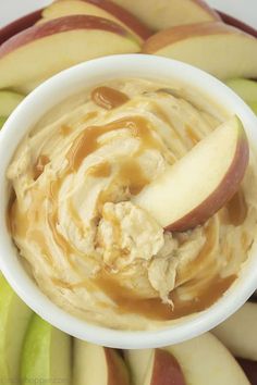 an apple and peanut butter dip in a white bowl