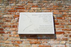 a brick wall with a plaque on it