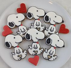 a white plate topped with cookies covered in frosting and decorated to look like dogs