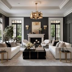 a living room filled with white couches and black chairs next to a fire place