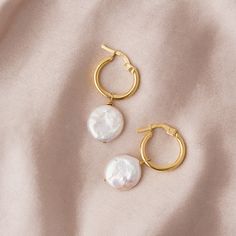 Meet our Round Pearl Drop Hoops. These earrings are crafted from 18k gold-plated recycled sterling silver, and feature beautiful chunky pearls. A unique design inspired by vintage jewellery of the past. This style also comes in silver.  Light-to-medium weight.  Waterproof, sweat-proof and life proof! All our jewellery is made of the highest quality materials and are free from nickel and brass, so won't ever tarnish, rust or turn your skin green!  Produced in limited quantities to avoid waste. Run, don't walk, to checkout to avoid missing out! 18k gold-plated recycled sterling silver, featuring beautiful chunky pearls.  LIGHT CLEANING We recommend gently cleaning your jewellery with a microfibre cloth or jewellery polishing cloth between wears.  DEEPER CLEANING Mix some dish soap in lukewar Chunky Pearls, Drop Hoop Earrings, Hoop Earrings Gold, Sweat Proof, Recycled Sterling Silver, Pearl Drop, Vintage Jewellery, Earrings Gold, Medium Weight