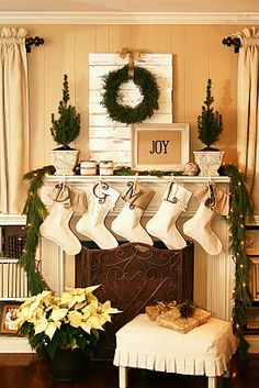 a fireplace decorated for christmas with stockings hanging from the mantel