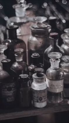 many medicine bottles are lined up on a shelf