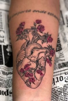 a heart tattoo with roses on it