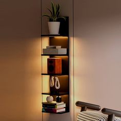 a room with a chair, bookshelf and plant on the wall next to it