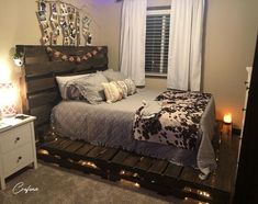 a bedroom with a bed made out of pallet wood and lights on the side