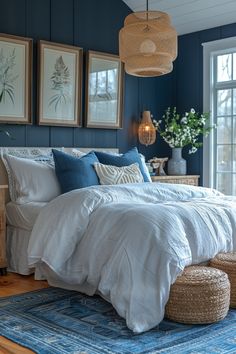 Cozy bedroom with dark blue walls, white bedding, wicker accents, and botanical art above the bed. Boho Room With Blue Accents, Blue Accent Wall Ideas, White Gold Room, Navy Blue Accent Wall, Accent Wall Inspiration, Blue Accent Wall, 2023 Bedroom, Wood Wainscoting, Blue Bedroom Walls