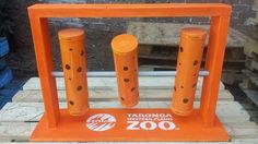 two orange poles sitting on top of a wooden pallet