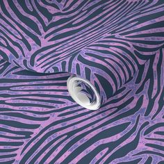 a purple and black zebra print wallpaper with a roll of tape on it's side