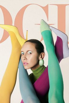 a woman is posing with her arms behind her head and legs painted multicolored