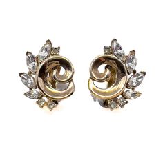 These stylish 1940s earrings were made by Trifari. Condition Report: Excellent The Details... These earrings are constructed from gold plated metal. They feature a swirl design detailed around its outer edge with colourless navette and round rhinestones. The earrings are clip on. They are signed - the reverse of each clip is stamped 'TRIFARI' with a crown above the 'T'. The earrings measure 2cm x 2.5cm.   Wear it With... Pair these earrings with a blazer and jeans for a timeless look.  Jewellery 1940 Jewelry Earrings, 1940s Earrings, 1940s Brooch, 1960s Sounthern Vintage Earrings Jewelry, Luxury Vintage Green Clip-on Earrings, Blazer And Jeans, Vintage Gold Clip-on Earrings With Rhinestones, Jewelry Manufacturers, Swirl Design