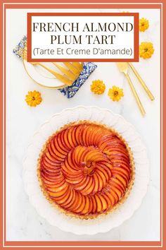 a pie with sliced peaches on top and the words french almond plum tart