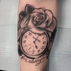 a black and white tattoo with a clock and rose on the arm that says, no time is always