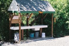 a small wooden shelter sitting in the middle of a forest