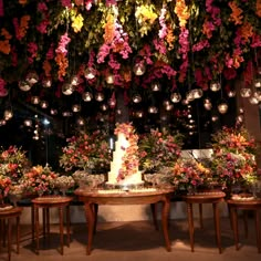 a table with flowers hanging from the ceiling