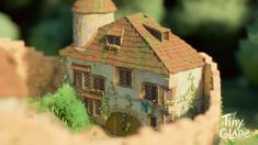 an image of a house that is made out of clay and paper with trees in the background