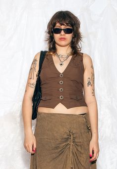 This Y2K vintage vest is like discovering a pocket full of fairycore grunge magic from the early 2000s. Features: - button closure - 100% cotton Every item we manage is cleaned and, when necessary, repaired, ensuring it arrives to you in top condition. Our model, Szedi is 170 cm / 66.3" tall and she's a size L. Size: M / US 6 / UK 10 / IT 42 Other size info: Labelled size: 38 Measurements:  width (seam to seam): 46 cm / 17.9" length: 52 cm / 20.3" Fabric: cotton 100% Care: Machine wash separatel Sleeveless Festival Vest With Pockets, Sleeveless Vest With Pockets For Festivals, Y2k Corset, Grunge Whimsigoth, Fairycore Grunge, Corset Vest, Vintage Vest, Summer 24, Vest Outfits