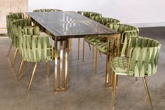 a dining room table with green chairs around it