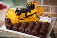 a table topped with doughnuts and a bulldozer