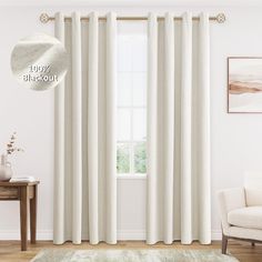 a living room with white curtains and a rug in front of the window that is open