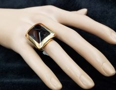 FASHION ITALIAN DESIGN 18K YELLOW SOLID GOLD BLACK ONYX RING CENTER NATURAL BLACK ONYX SIZE 20X15 GORGEOUS BLACK ONYX CLEAN ,VERY NICE CUT ,LIVELY STONE.NICE LUSTER. RING size 6.5 Ring measure one inch long 28mmx21mm Ring weighs 19.7 grams Retail value $8,500 net . Appraisal available Designer Yellow Gold Rings For Evening, Designer Black Enamel Rings For Gift, Designer Black Ring With Black Enamel, Designer Black Enamel Ring, Gold Gemstone Rings For Evening, Formal Gold Onyx Rings, Designer Black Rings For Anniversary, Gold Rings With Polished Finish For Evening, Vintage Platinum Rings