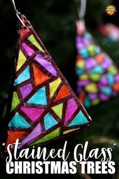 colorful stained glass ornaments hanging from a christmas tree ornament in the shape of a triangle