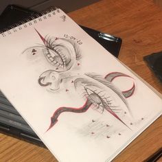 a pencil drawing of a dragon on top of a desk next to a laptop computer