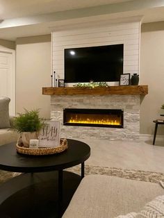 a living room with a fireplace and television