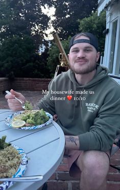 a man sitting at a table with food in front of him and the caption reads, my housewife made us dinner