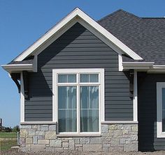 a gray house with white trim and windows