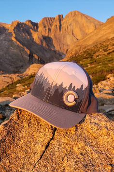 Looking for a new addition to your Colorado Hat collection that is a little different than what you already have? Our new Alpine Snapback hat features a Colorado Rocky Mountain / treeline silhouette in an indigo, white and gray color scheme, topped off with a Colorado Flag C. If you want a hat that combines several great elements of our epic state in a nice, clean color scheme that isn't too loud, this is a perfect Colorado hat for you.  Buy now and rep Colorado with style!! Treeline Silhouette, Too Loud, Grey Color Scheme, Hat Collection, Rocky Mountain, Rocky Mountains