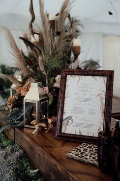 a wooden table topped with lots of plants and a framed menu on top of it