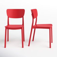 two red chairs sitting next to each other on a white surface with one chair facing the other