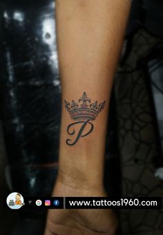 a person with a crown tattoo on their arm and the letter p tattooed to it