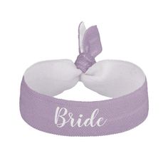 a purple and white headband with the word bride on it