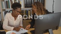 Women Discussing Documents In An Office Workspace While Seated At A Desk Wi.. Office Workspace, A Desk, Working Together, Work Space, Hold On