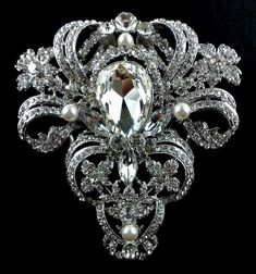 "An old hollywood glamour statement wedding broach featuring ornate and detailed Victorian motifs. This stunning bridal brooch is made of clear swarovski crystals with handwired pearls, set on silver rhodium finish. Broach is big and wide, measures about 3 1/4\" (8.5cm) x 3 1/2\" (9cm) at its widest. View other Victorian inspired accessories https://etsy.me/2uAseFc View all brooch pins at https://etsy.me/1eEBStU * Bride's pics are credit and courtesy of our satisfied bride" Glam Wedding Bouquet, Elegant Pearl Jewelry, Wedding Brooches, Bridal Brooch, Pearl Jewelry Wedding, Bridal Fashion Jewelry, Victorian Wedding, Wedding Brooch, Vintage Style Wedding