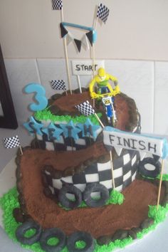 a cake made to look like a dirt bike race track with the number 3 on it