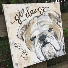 a painting of a dog on a wooden sign