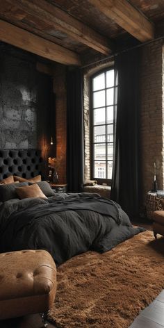 a large bed in a bedroom next to a window with black curtains and brown rugs