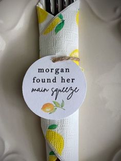 a napkin wrapped in white paper with lemons on it and the words morgan found her main squeeze