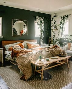 a bed room with a neatly made bed next to a chair and mirror on the wall