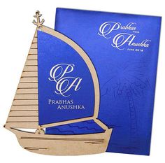 a blue book with a wooden sailboat on it's cover and the words prabhas anushka written in arabic