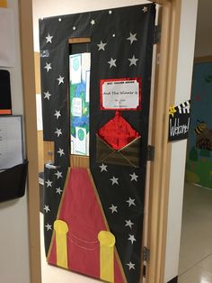 a door decorated to look like a rocket ship with red carpet and stars on it