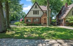 this is an image of a house in the suburbs with trees and grass around it