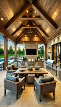 an outdoor kitchen and living room with wood ceilinging