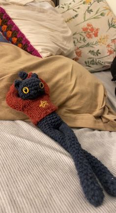 a crocheted stuffed animal laying on top of a bed