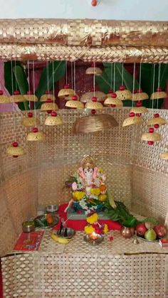 an arrangement of food and decorations on a table in a room with wicker walls