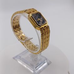 This goregeous gold plated ladies watch has a black face, gold hands and gold hour markers. There are 2 tiny clear gems at the 12 mark. The band is a brushed and polished triple straight stacked flexible link band. The inside of the band is entirely polished and very shiny. The back of the watch is stamped "Patent by  18k Gold electroplated  Water resistant   shock proof" The watch measures roughly 3/4 inch wide and 7.5 inches long. Previously owned, shows some very minimal signs of wear. Overall in great condition. Brand new battery installed and keeps perfect time. Thanks so much for looking! If you have any questions, concerns or if I forgot to mrntion something you find relevent, please do not hesitate to reach out to me! I usually respond quickly. For other vintage watches I have for Gold Hands, Women Wrist Watch, I Forgot, Ladies Watch, Vintage Watches, Womens Watches, Wrist Watch, 4 Inch, Jewelry Watches